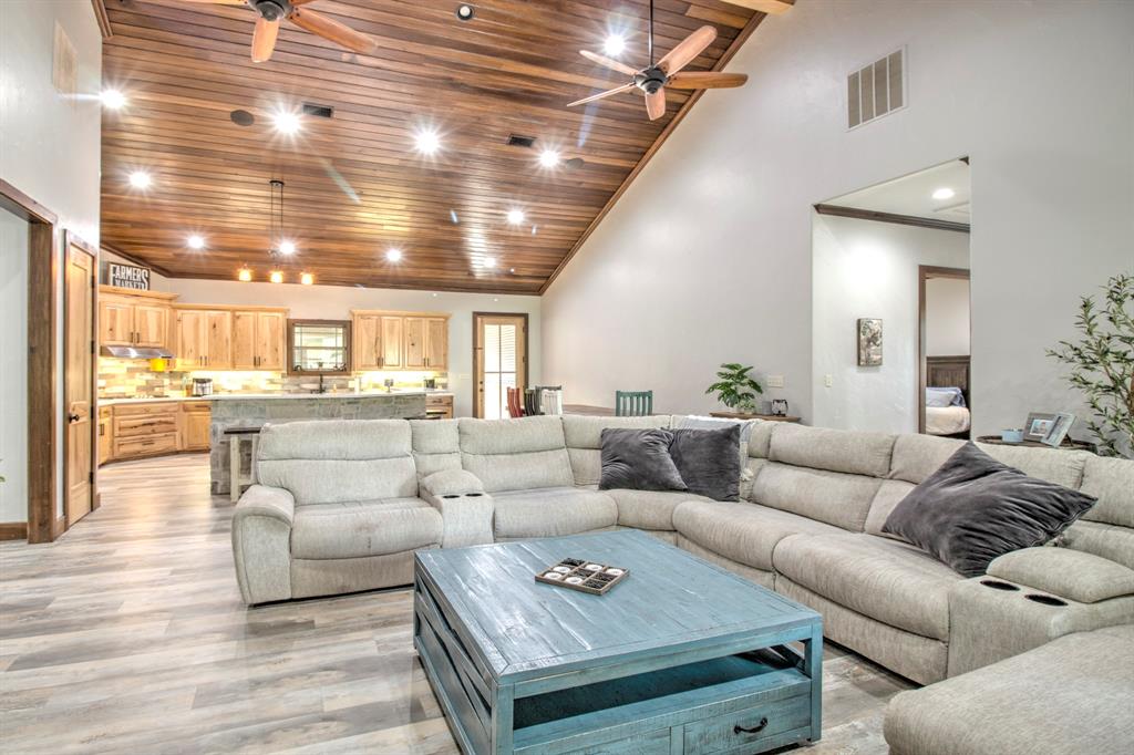 1024 Jordan Creek Road Collinsville, TX 76233 - Photo 7 of 40 This expansive open-concept living area perfectly captures the essence of modern rustic living.