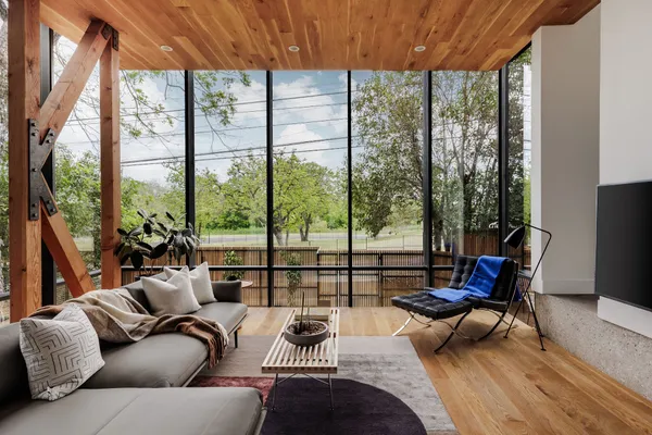 a living room with furniture and a floor to ceiling window