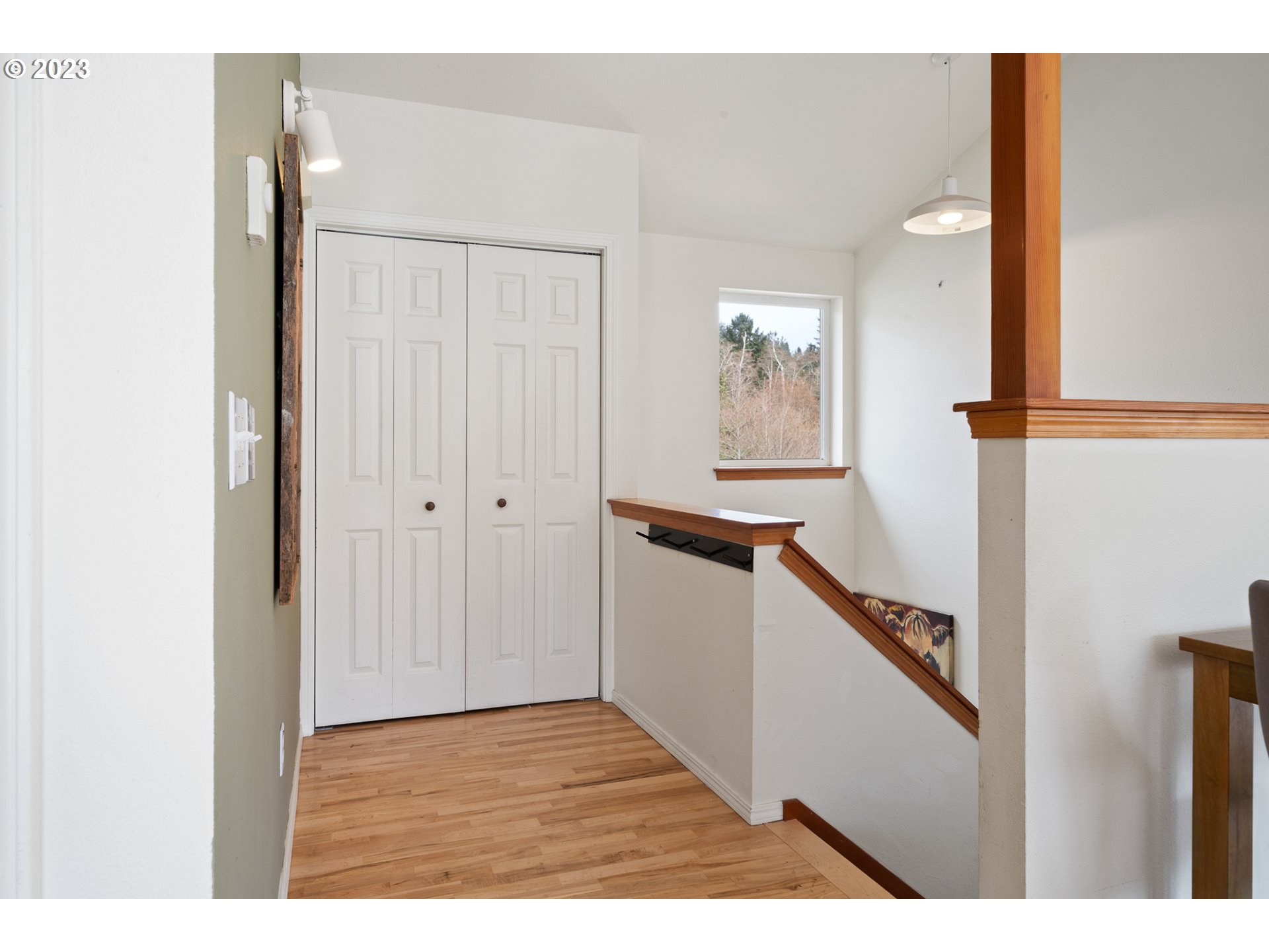 8189 Nehalem Road Manzanita, OR 97130 - Photo 17 of 30 a view of a hallway with wooden floor and staircase