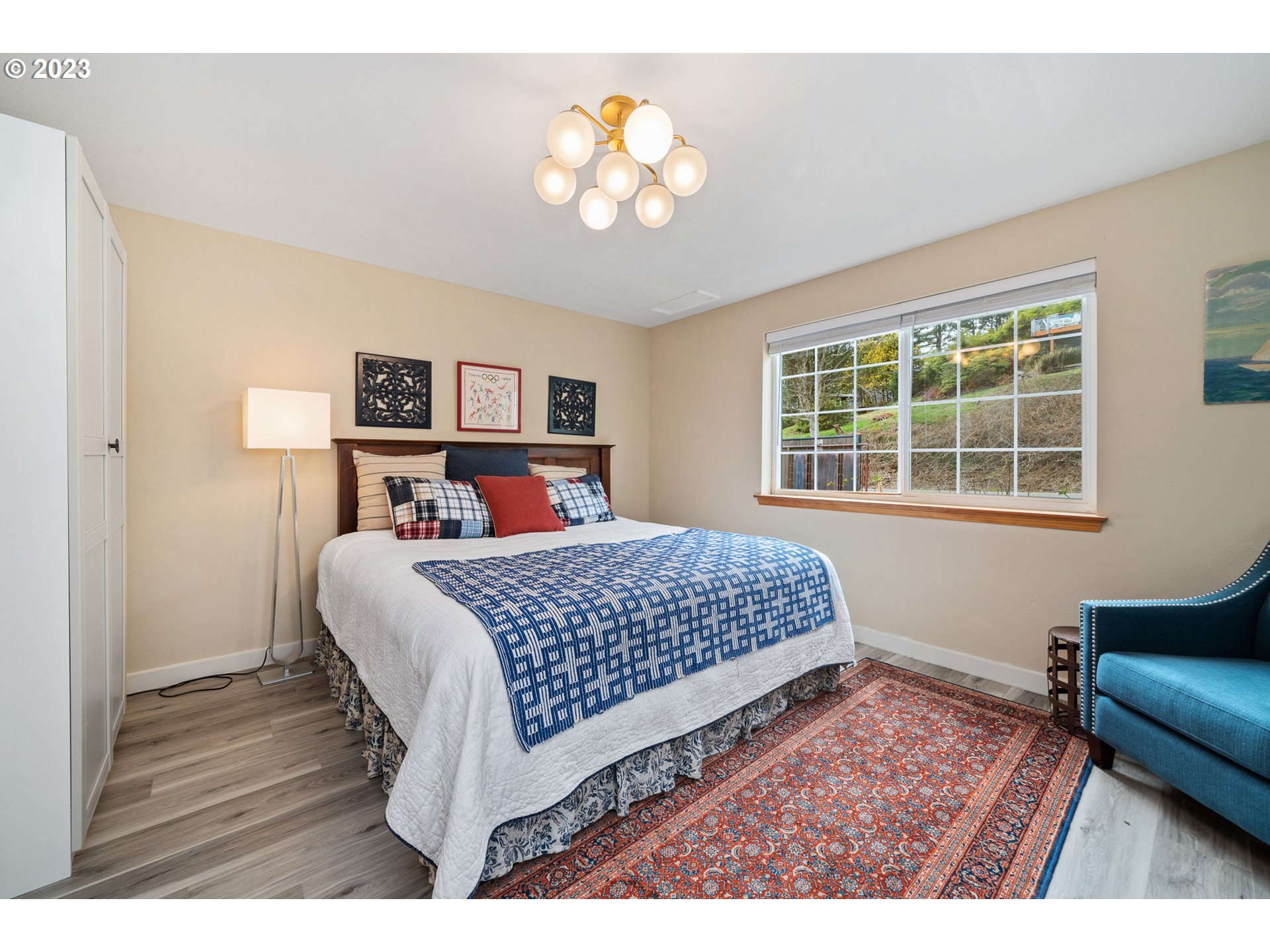 8189 Nehalem Road Manzanita, OR 97130 - Photo 21 of 30 a bedroom with a large bed and a couch