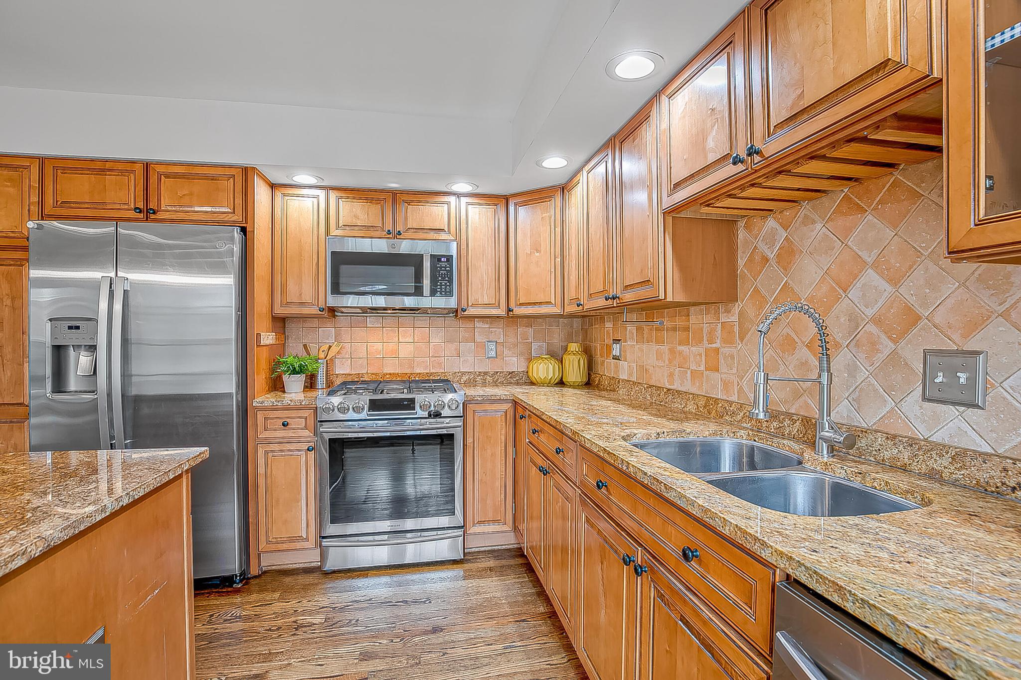 1824 Duffield Lane Alexandria, VA 22307 - Photo 11 of 64 a kitchen with stainless steel appliances granite countertop a sink a stove and refrigerator