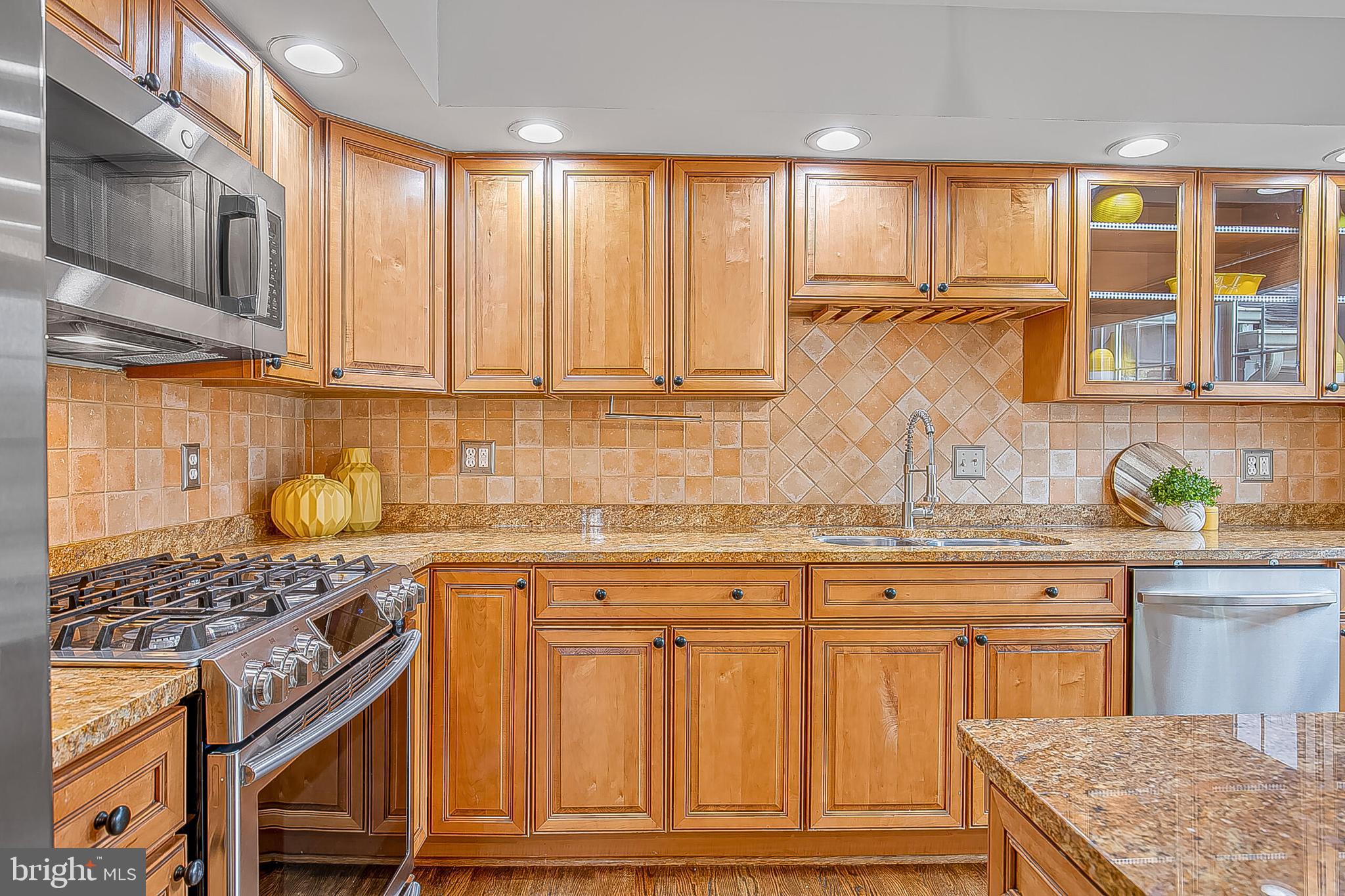 1824 Duffield Lane Alexandria, VA 22307 - Photo 8 of 64 a kitchen with granite countertop wooden cabinets and a stove