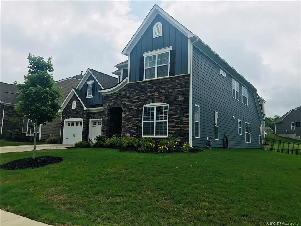 566 Brookhaven Drive, Unit 89 Fort Mill, SC 29708 - Photo 2 of 22 a front view of a house with a yard