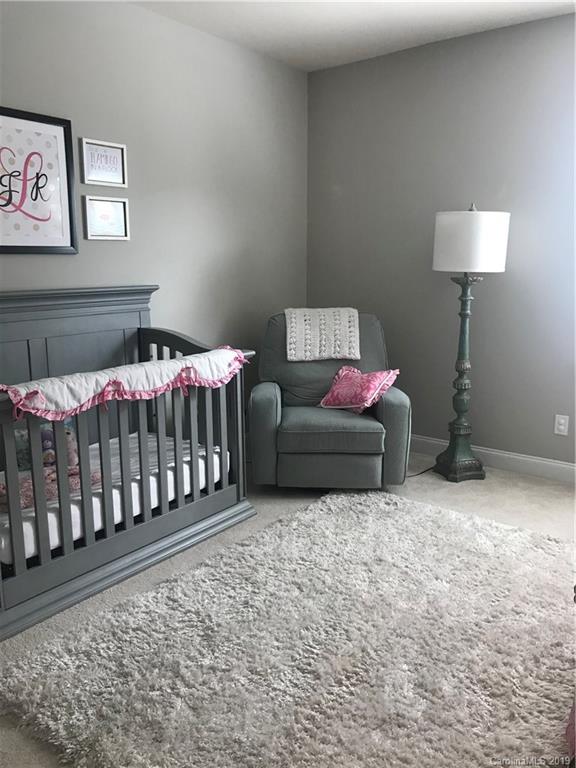 566 Brookhaven Drive, Unit 89 Fort Mill, SC 29708 - Photo 12 of 22 a bedroom with furniture and a bed