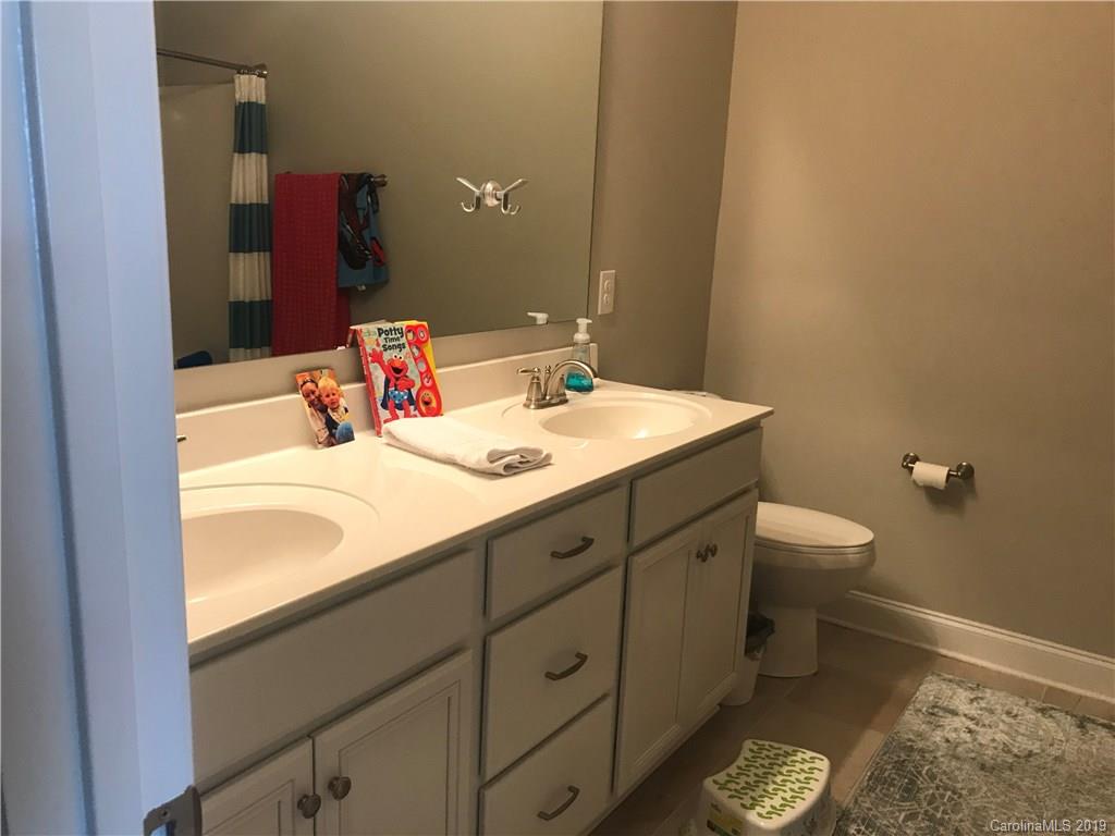 566 Brookhaven Drive, Unit 89 Fort Mill, SC 29708 - Photo 13 of 22 a bathroom with a sink and a mirror