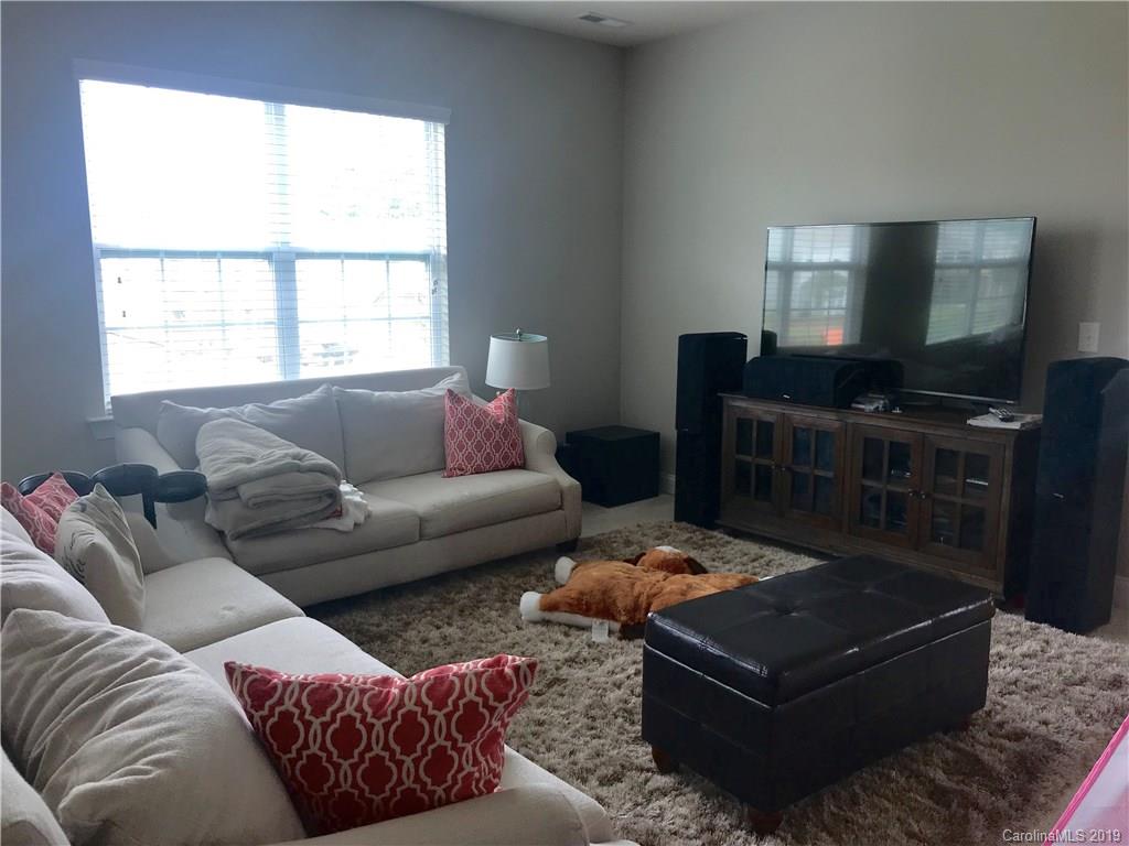 566 Brookhaven Drive, Unit 89 Fort Mill, SC 29708 - Photo 14 of 22 a living room with furniture and a flat screen tv