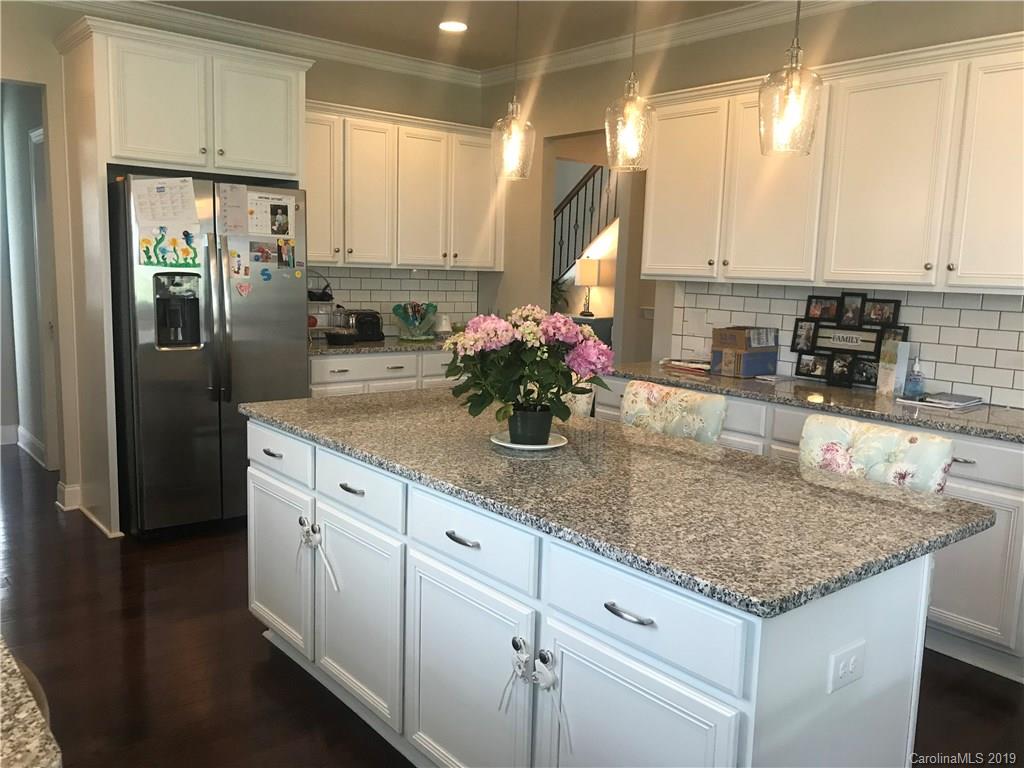 566 Brookhaven Drive, Unit 89 Fort Mill, SC 29708 - Photo 17 of 22 a kitchen with stainless steel appliances granite countertop a sink a refrigerator and white cabinets