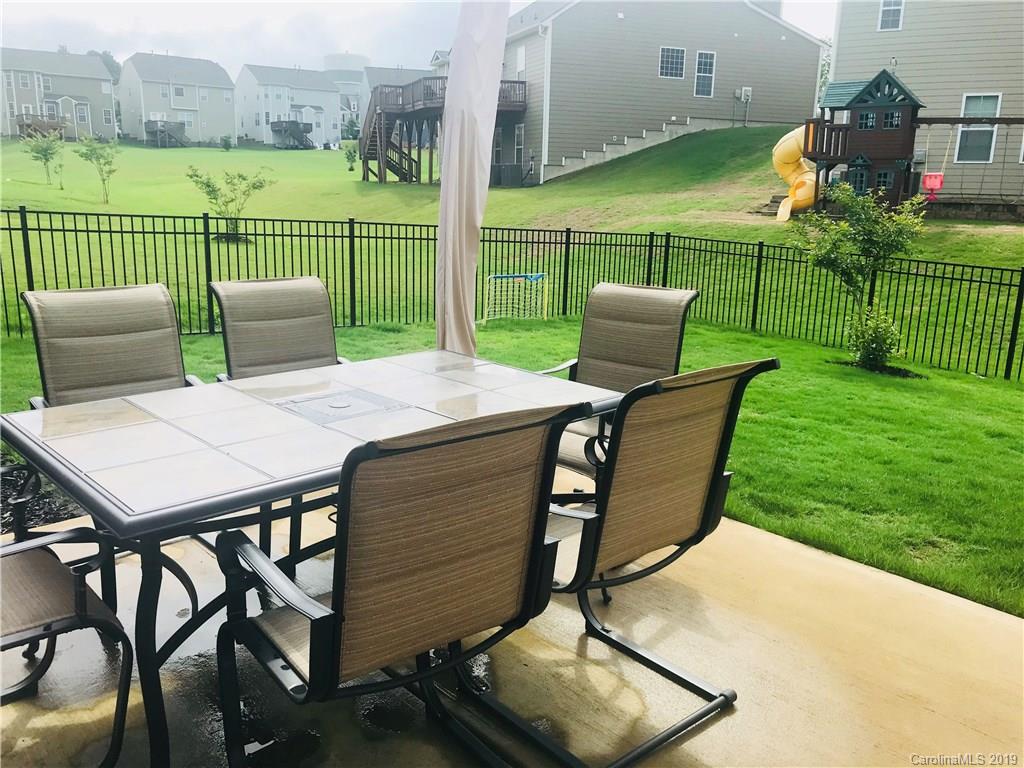 566 Brookhaven Drive, Unit 89 Fort Mill, SC 29708 - Photo 21 of 22 a view of a chairs and table in the yard