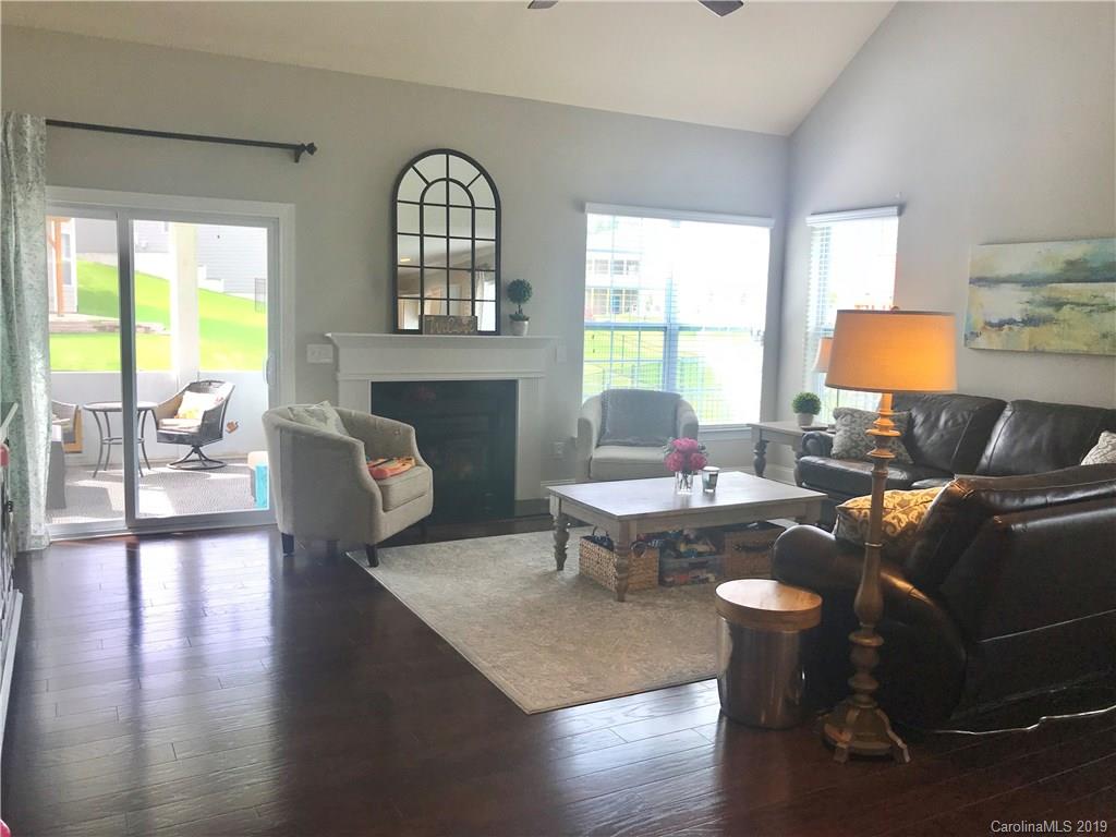 566 Brookhaven Drive, Unit 89 Fort Mill, SC 29708 - Photo 4 of 22 a living room with fireplace furniture and a large window