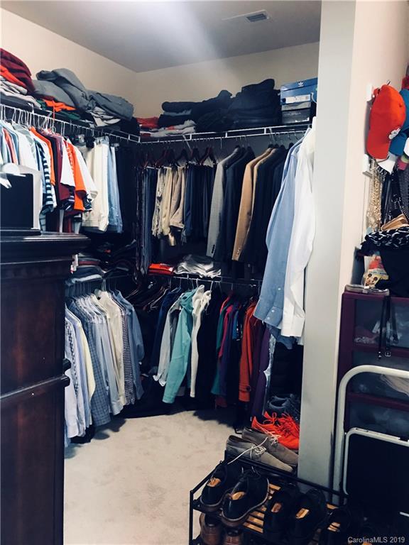 566 Brookhaven Drive, Unit 89 Fort Mill, SC 29708 - Photo 5 of 22 a view of walk in closet with clothes and shoes