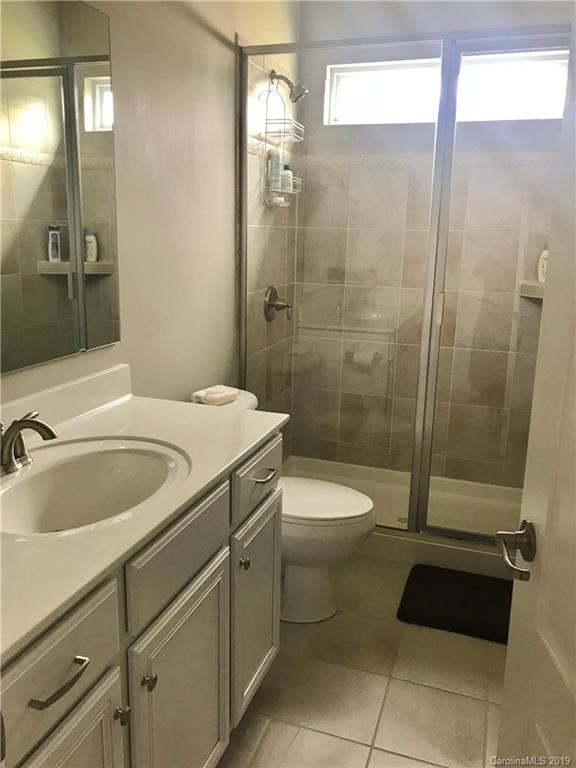 566 Brookhaven Drive, Unit 89 Fort Mill, SC 29708 - Photo 9 of 22 a bathroom with a sink a toilet and shower