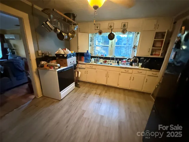a kitchen with stainless steel appliances granite countertop a stove and wooden floor