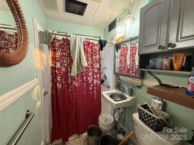 a bathroom with a toilet and a shower curtain