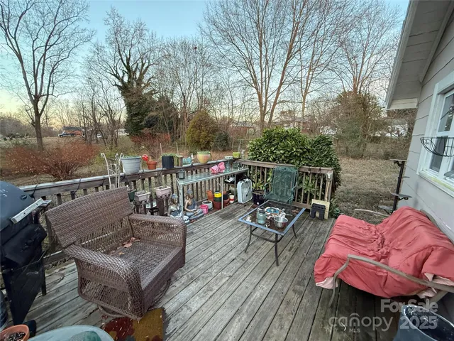 a view of a deck with couches table and chairs and wooden floor