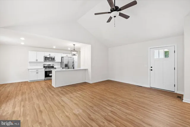 a view of a kitchen with microwave and cabinets