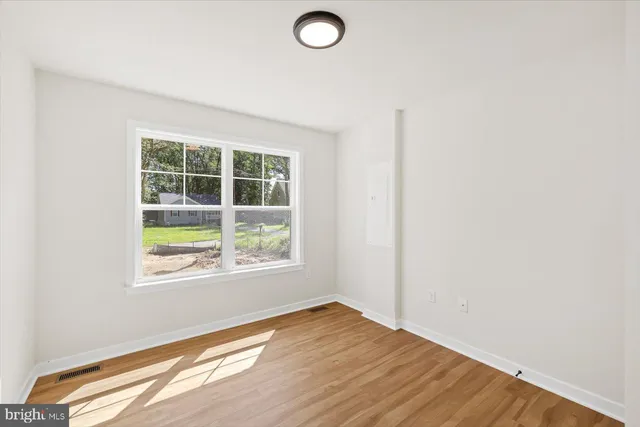 a view of a room with wooden floor