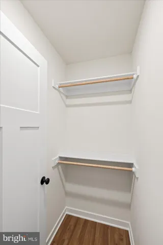 a bathroom with a granite countertop toilet a sink and a window
