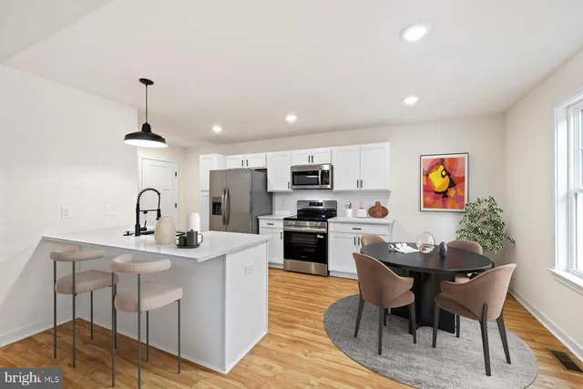 a living room with furniture a dining table and kitchen view