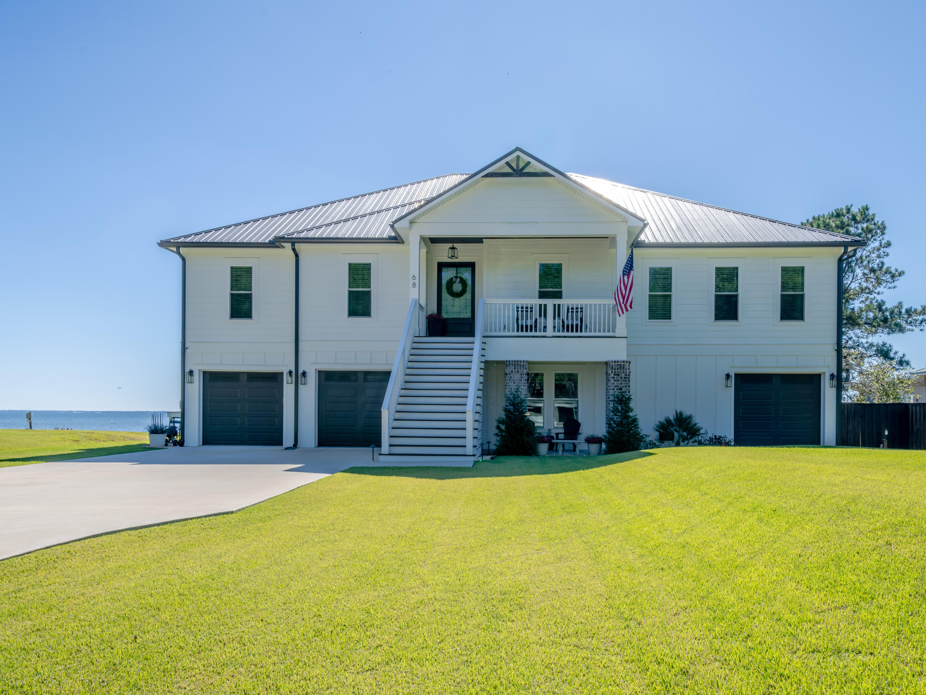 68 Dolphin Place Freeport, FL 32439 - Photo 11 of 118 a front view of a house with a yard