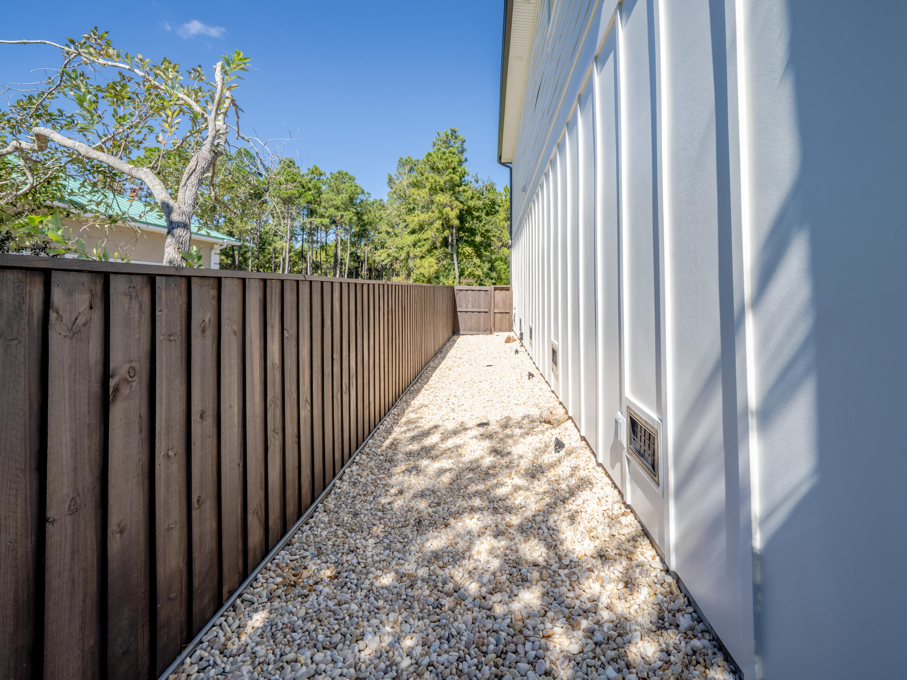 68 Dolphin Place Freeport, FL 32439 - Photo 117 of 118 a view of a pathway of a balcony with wooden floor and fence