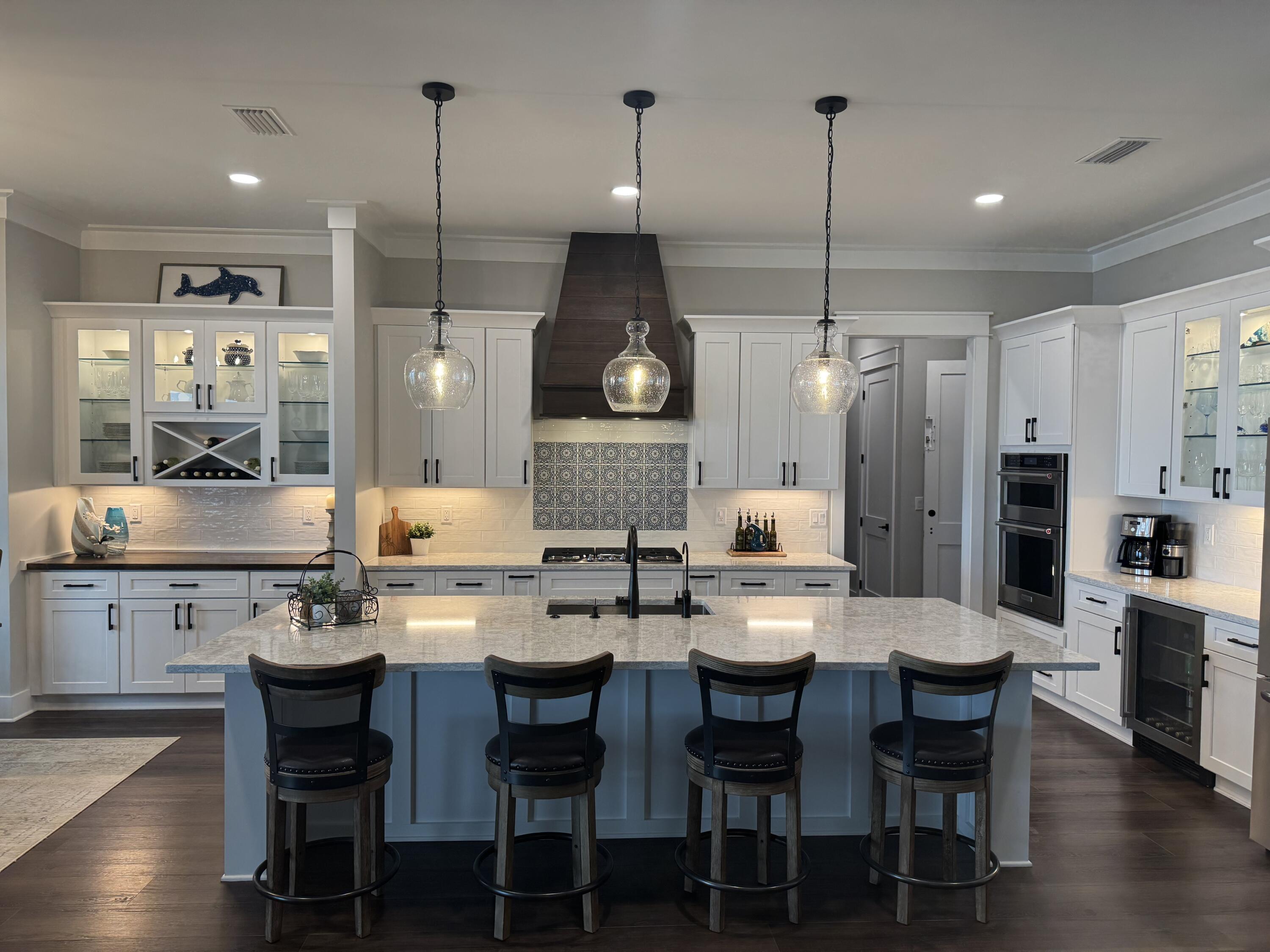 68 Dolphin Place Freeport, FL 32439 - Photo 21 of 118 a kitchen with stainless steel appliances a dining table chairs stove and white cabinets