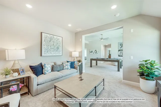 a living room with furniture and a potted plant