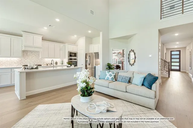 a living room with granite countertop furniture kitchen view and a potted plant