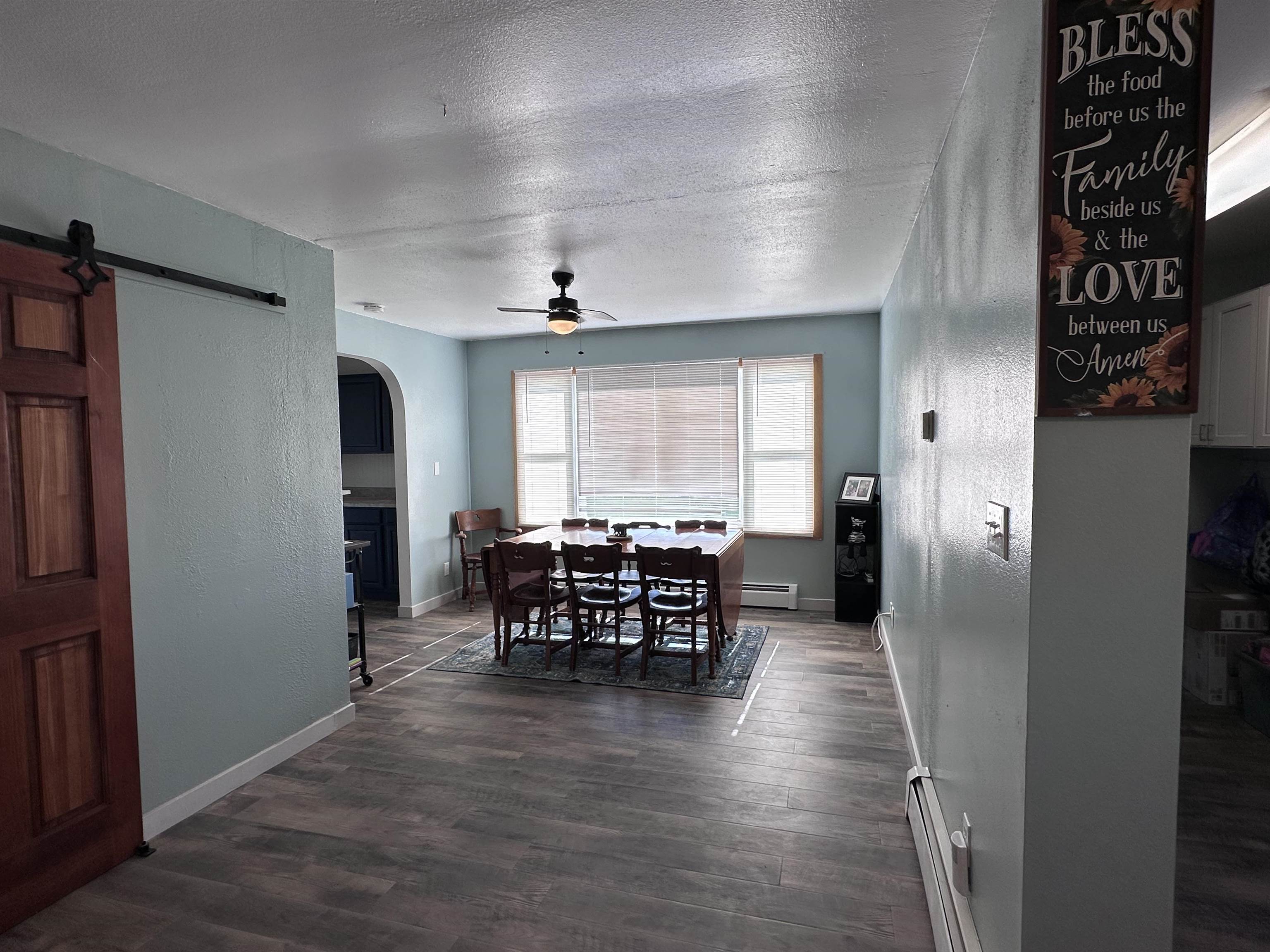 9456 6075th Road Montrose, CO 81403 - Photo 3 of 36 a view of a dining room with furniture window and wooden floor