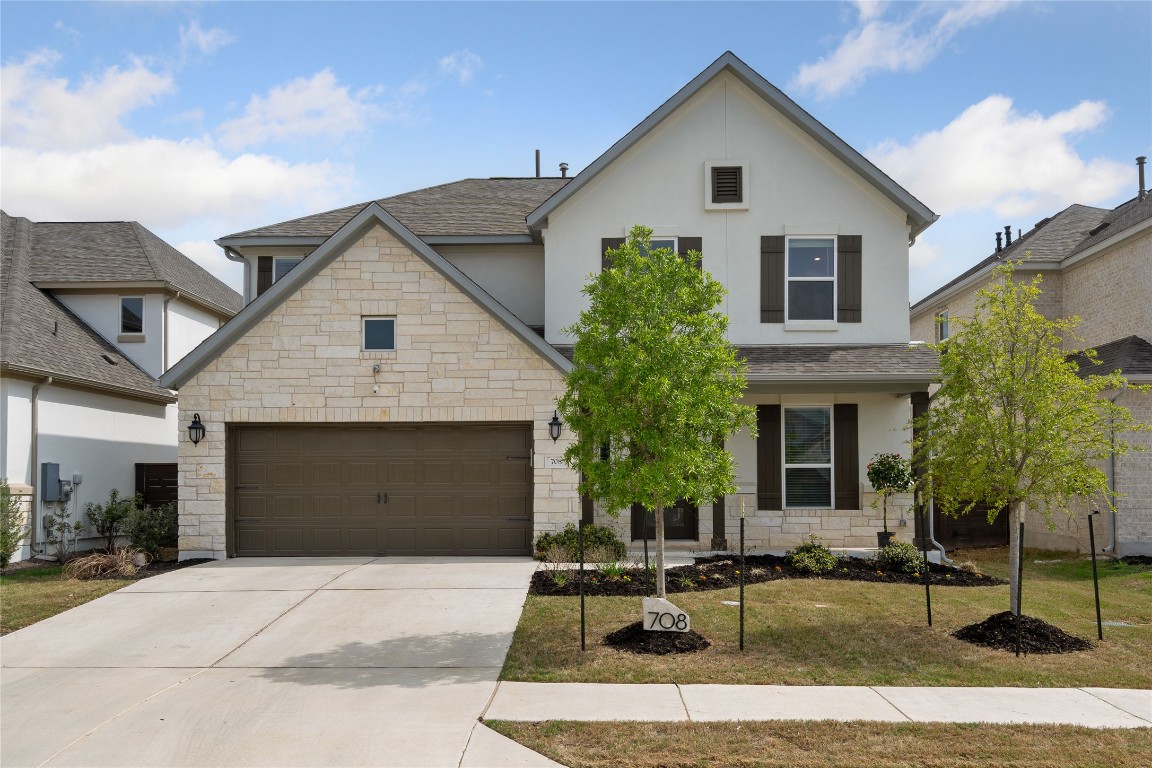 a front view of house with yard outdoor seating and garage