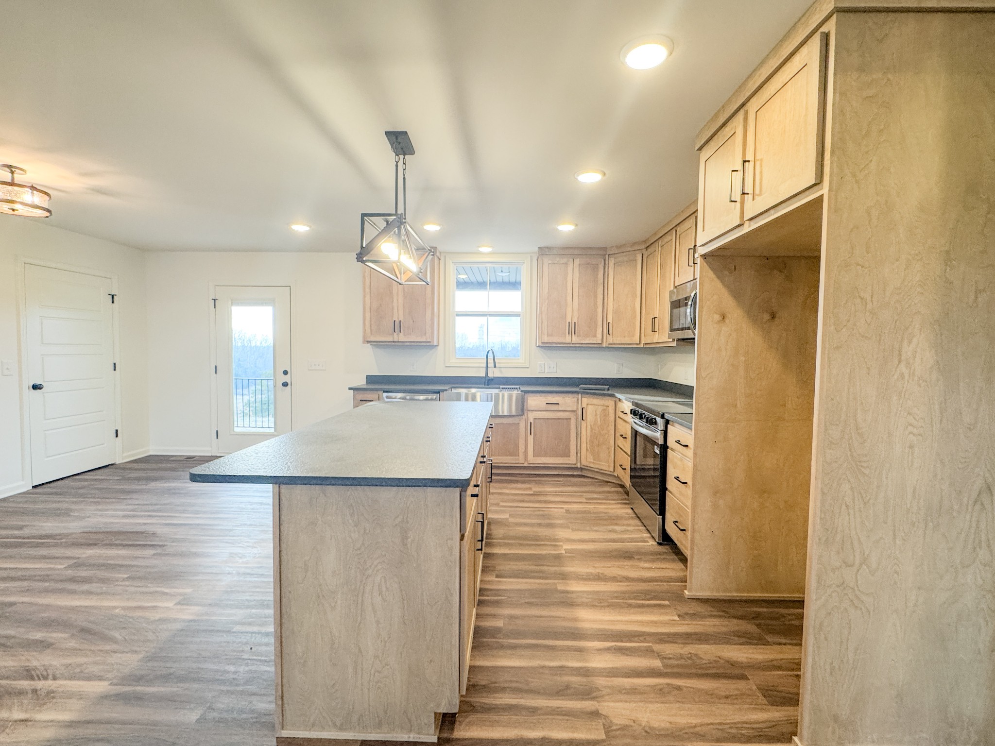 517 Pleasant Hill Road Lafayette, TN 37083 - Photo 11 of 39 a view of a kitchen with kitchen island wooden floor and center island