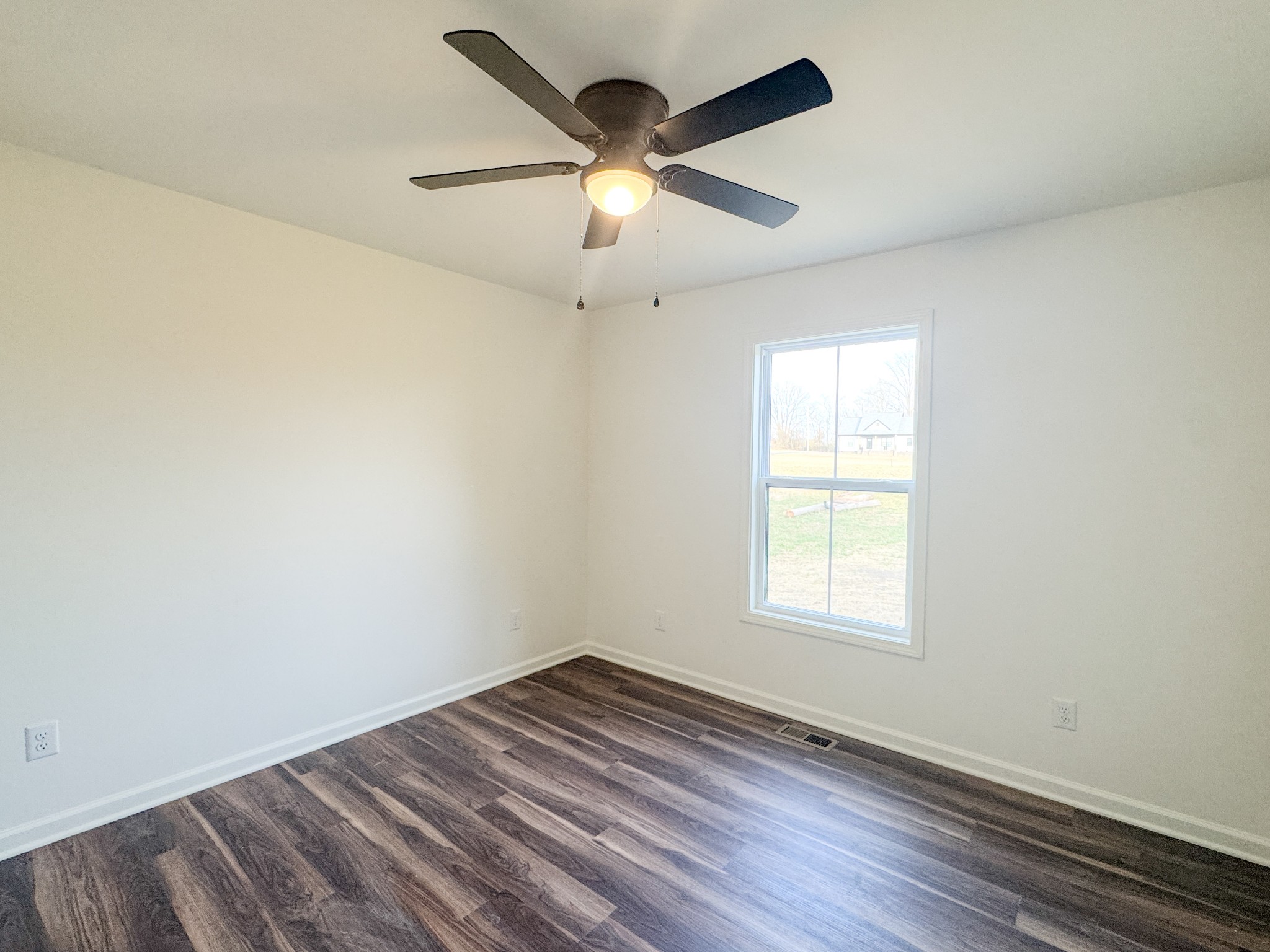 517 Pleasant Hill Road Lafayette, TN 37083 - Photo 21 of 39 an empty room with wooden floor and windows