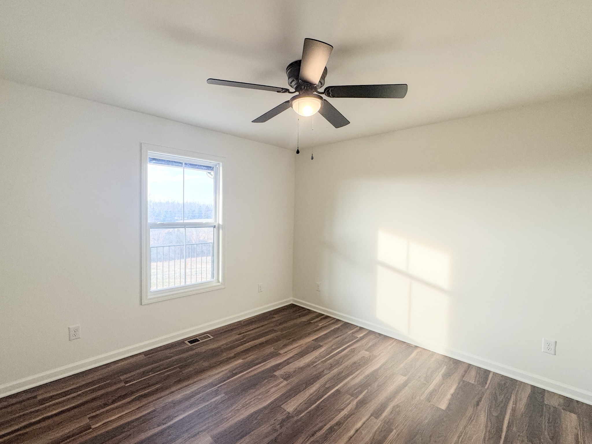 517 Pleasant Hill Road Lafayette, TN 37083 - Photo 25 of 39 wooden floor in an empty room with a window