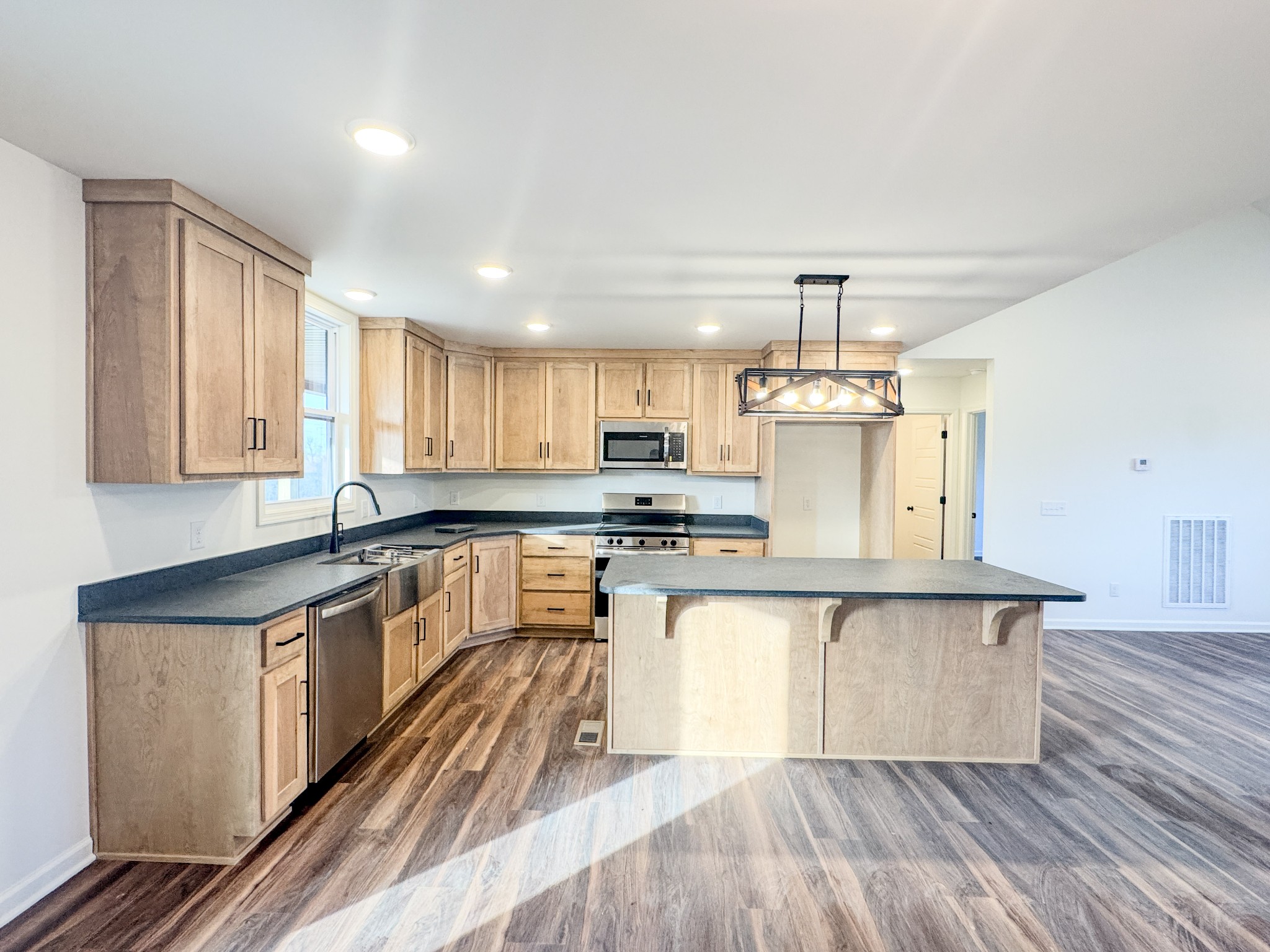 517 Pleasant Hill Road Lafayette, TN 37083 - Photo 10 of 39 a large kitchen with stainless steel appliances granite countertop a stove and a sink