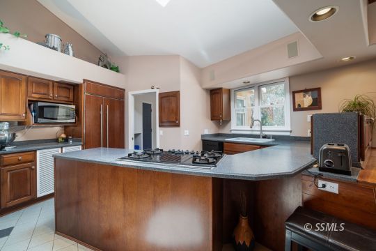 3835 West Ridgecrest Boulevard Ridgecrest, CA 93555 - Photo 18 of 50 a kitchen with stainless steel appliances granite countertop a sink a stove and a refrigerator