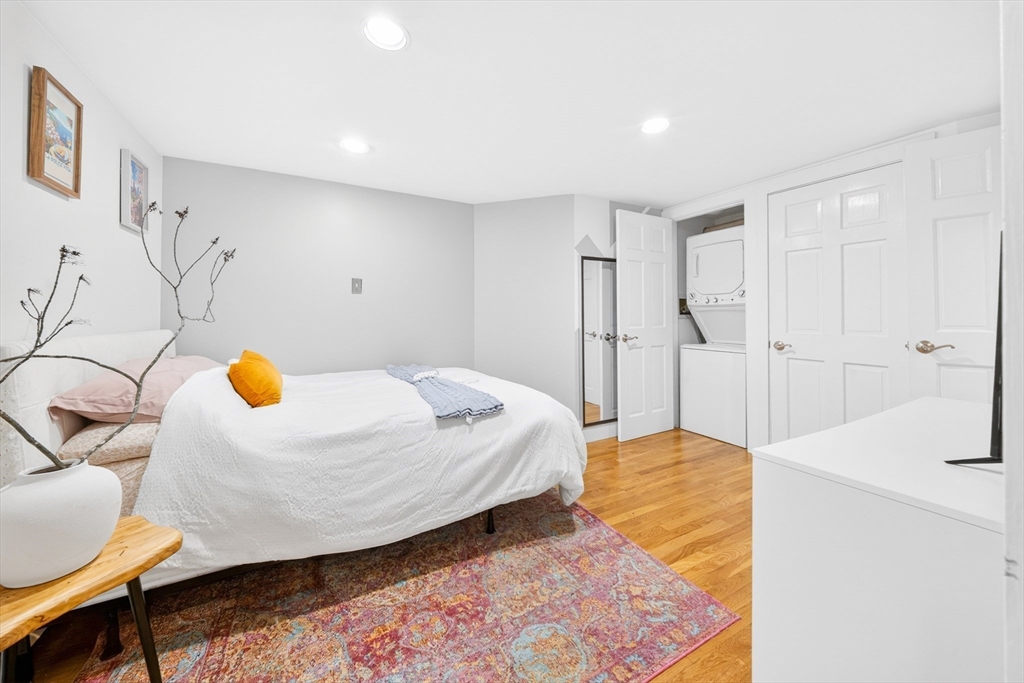 352 Tappan Street, Unit 1 Brookline, MA 02445 - Photo 23 of 42 a bedroom with a bed and a chandelier