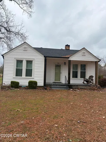 a front view of a house with yard patio and porch