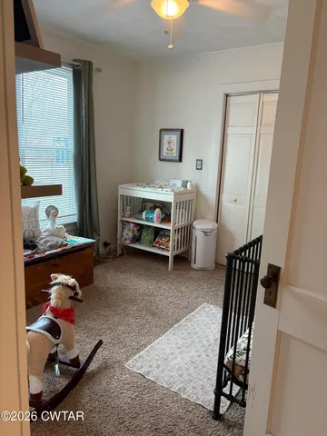 a bedroom with furniture and a window