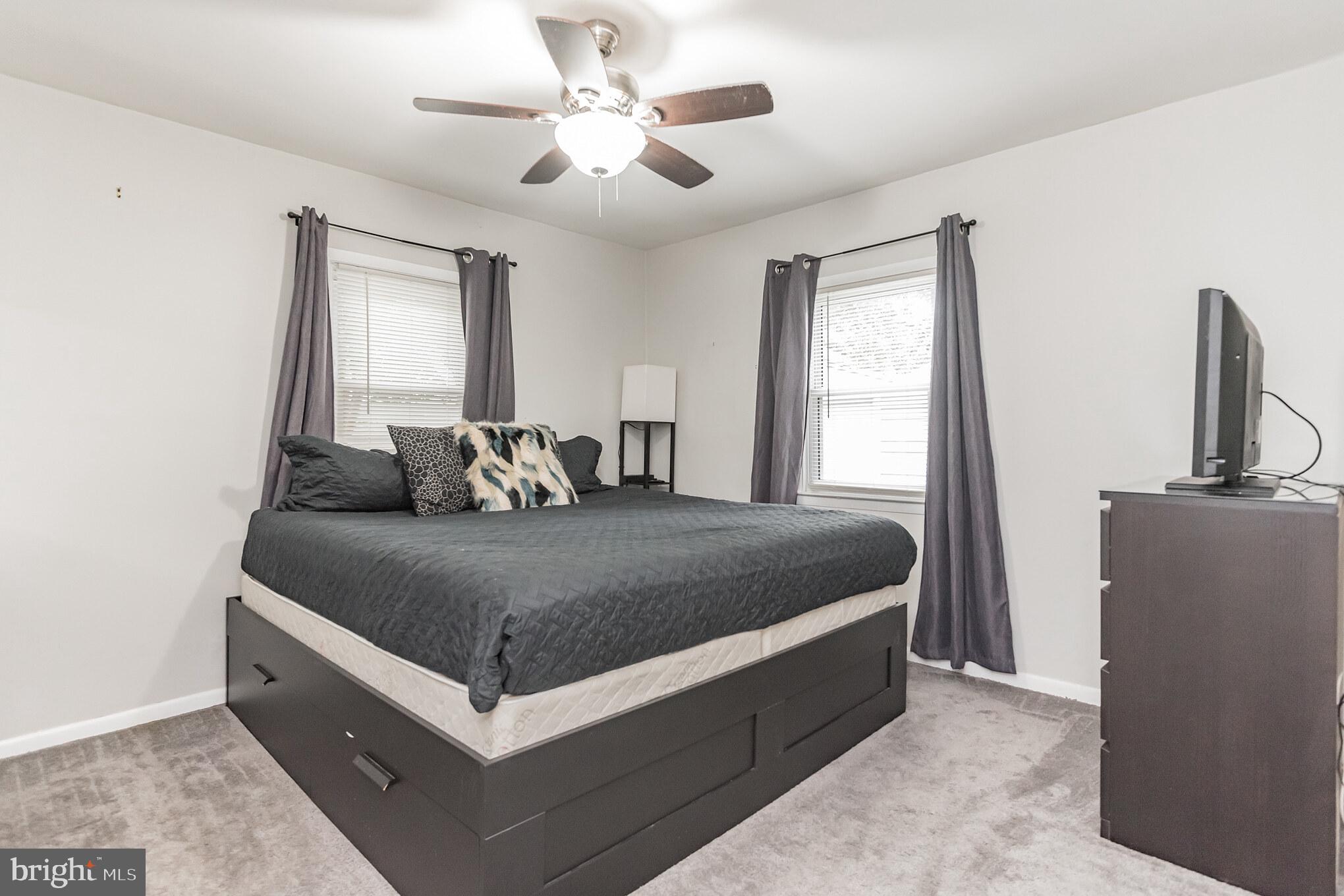 1729 Ridgely Road Edgewater, MD 21037 - Photo 18 of 29 a bed room with a bed and a chandelier