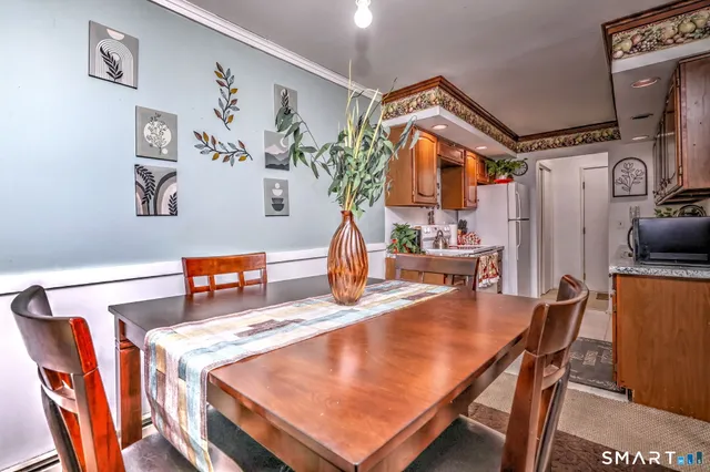 a dining room with furniture and wooden floor