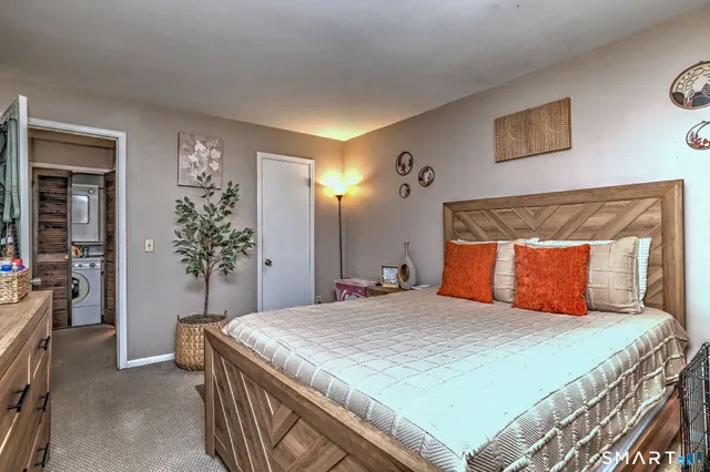 a bedroom with a large bed and a chandelier