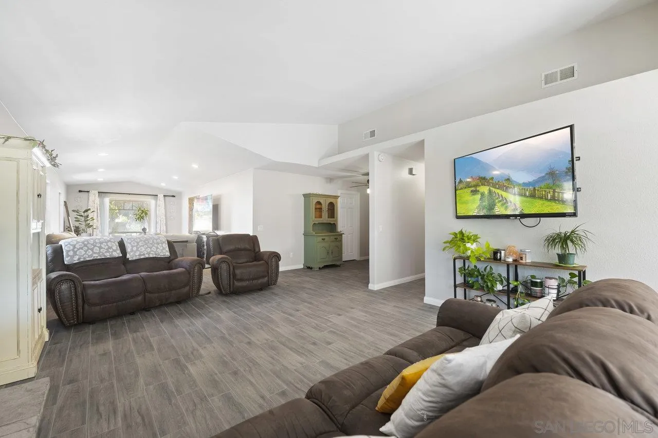 607 Maybritt Circle San Marcos, CA 92069 - Photo 13 of 38 a living room with furniture and a wooden floor