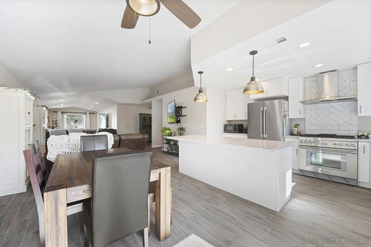 607 Maybritt Circle San Marcos, CA 92069 - Photo 16 of 38 a living room with stainless steel appliances kitchen island granite countertop furniture and a kitchen view