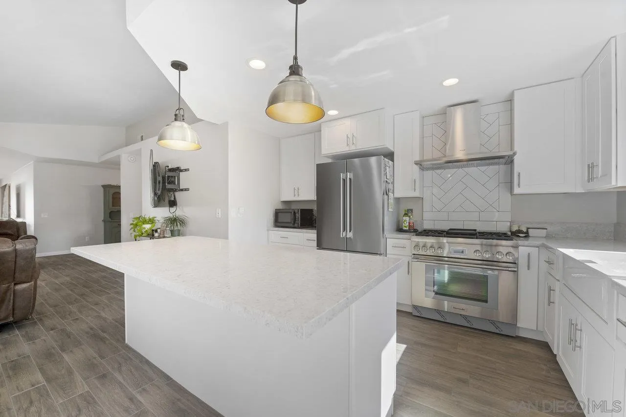 607 Maybritt Circle San Marcos, CA 92069 - Photo 17 of 38 a kitchen with stainless steel appliances a refrigerator sink and stove