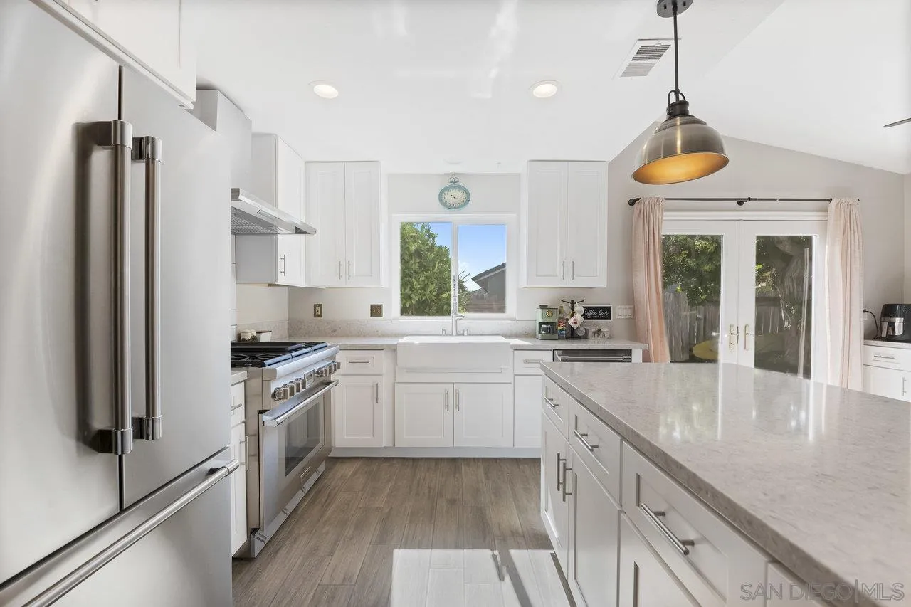 607 Maybritt Circle San Marcos, CA 92069 - Photo 20 of 38 a large kitchen with stainless steel appliances granite countertop a stove a sink and a refrigerator