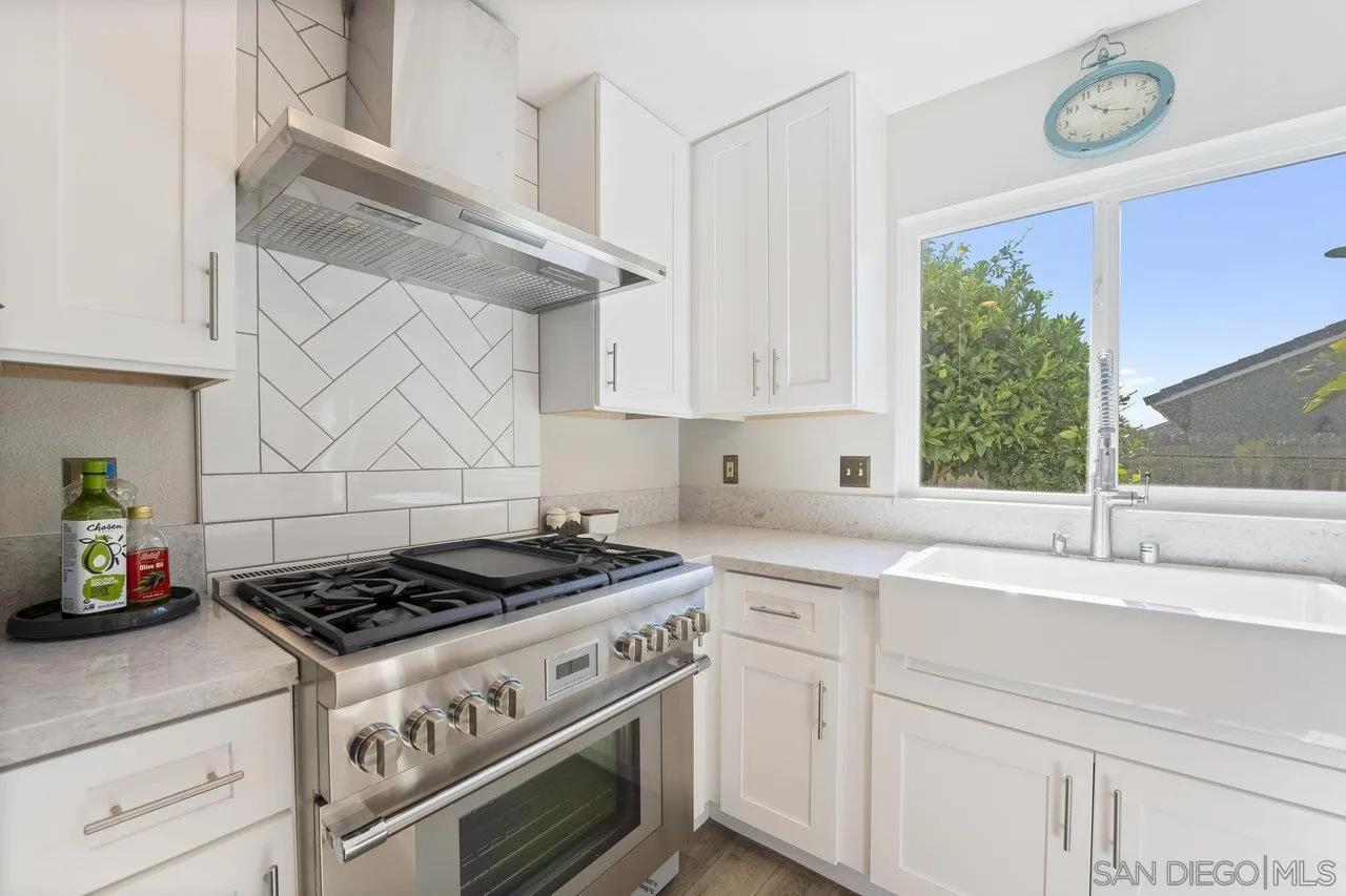 607 Maybritt Circle San Marcos, CA 92069 - Photo 21 of 38 a kitchen with stainless steel appliances granite countertop a stove a sink and a white cabinets