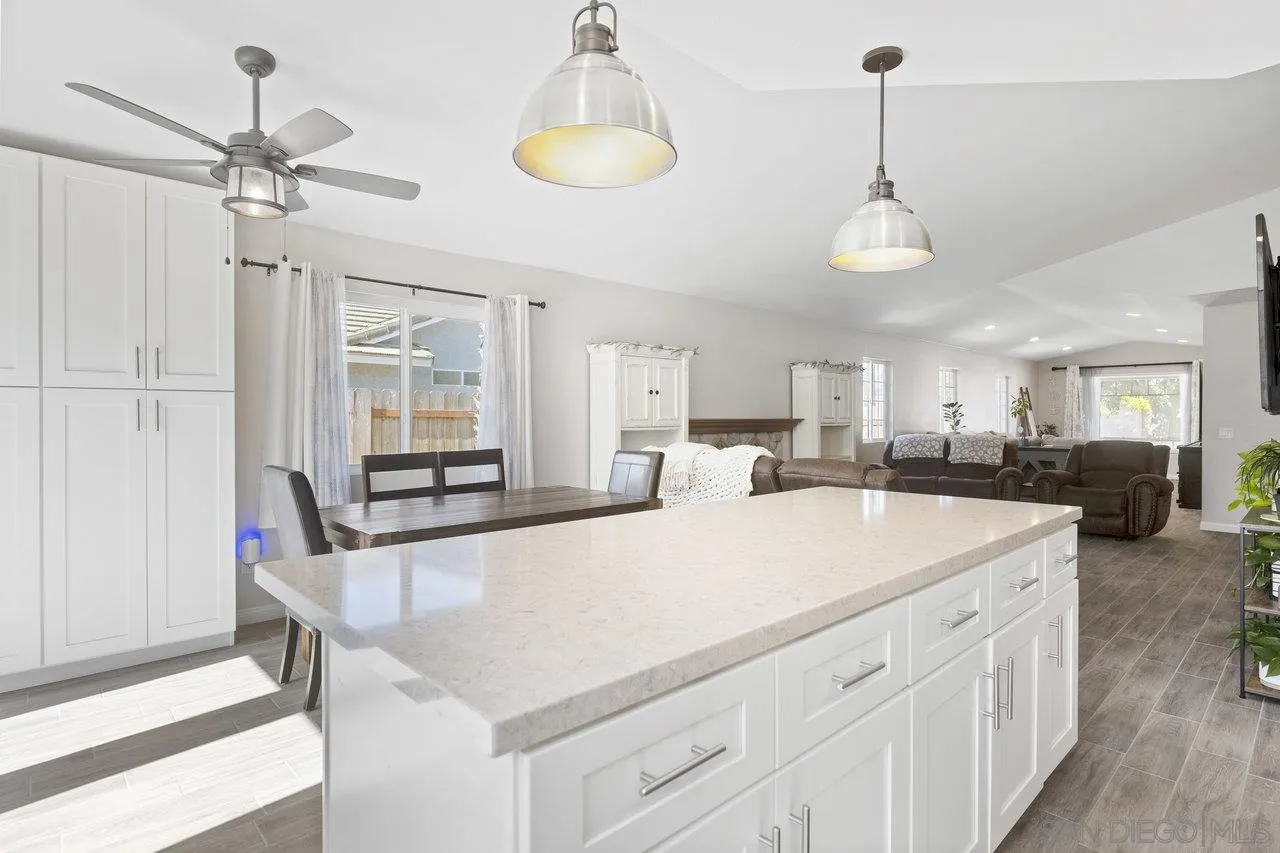 607 Maybritt Circle San Marcos, CA 92069 - Photo 22 of 38 a large white kitchen with a table and chairs
