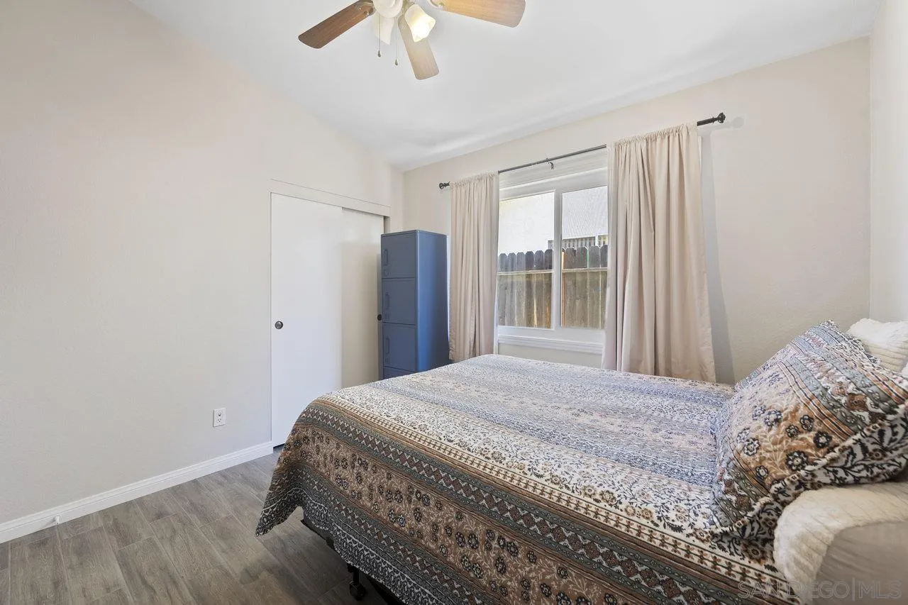607 Maybritt Circle San Marcos, CA 92069 - Photo 26 of 38 a bedroom with a large bed and a window