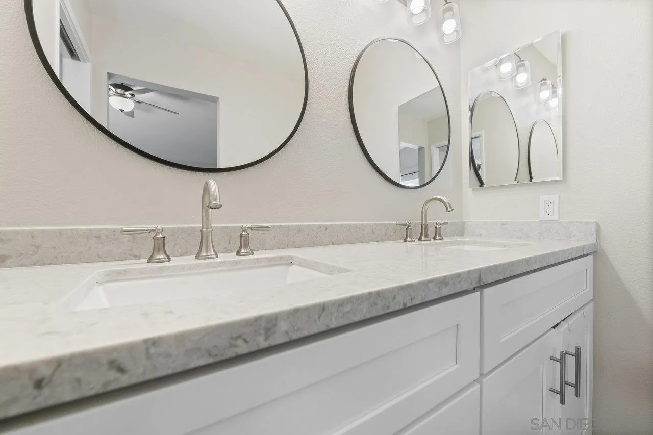 607 Maybritt Circle San Marcos, CA 92069 - Photo 28 of 38 a bathroom with a double vanity sink and a mirror