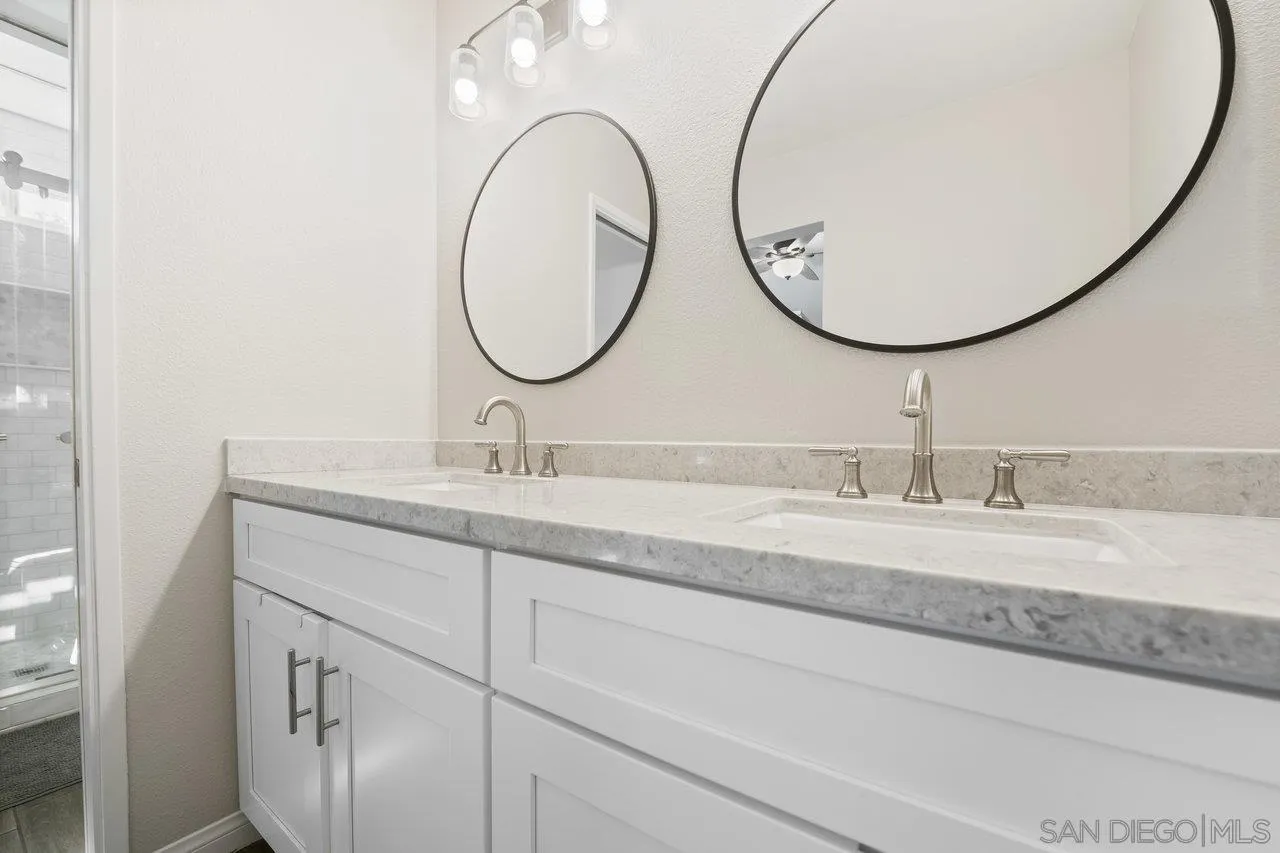 607 Maybritt Circle San Marcos, CA 92069 - Photo 29 of 38 a bathroom with a sink and a mirror