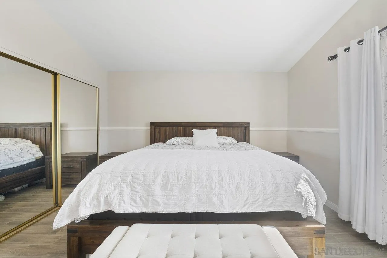 607 Maybritt Circle San Marcos, CA 92069 - Photo 31 of 38 a bedroom with a bed and wooden floor